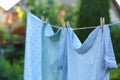 Washing line with drying shirts against blurred background, closeup Royalty Free Stock Photo