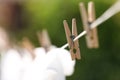 Washing line with wooden clothespin outdoors, closeup. Drying clothes Royalty Free Stock Photo