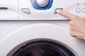 Washing machine button female hand Royalty Free Stock Photo