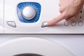 Washing machine button female hand Royalty Free Stock Photo