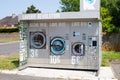 Washing machine and clothes dryer on a street in France, public laundry, sharing of electrical devices, eco friendly lifestyle