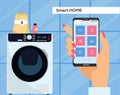 Washing machine controlled via smartphone with wi-fi. Smartphone remote control app. Female Hand holds mobile phone with Royalty Free Stock Photo