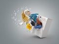Washing machine and flying clothes on grey background