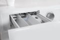 Washing machine with open detergent drawer, closeup.