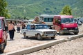 Washing machine placed on an old and rusty VAZ 2106 Zhiguli Soviet car roof rack , a traditional form of transportation of various