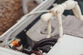 washing machine repair concept. A human figurine looks at the electrical circuits of a dismantled stylish car