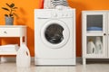 Washing machine, towels and detergents in laundry room Royalty Free Stock Photo