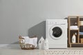 Washing machine, towels and detergents in laundry room Royalty Free Stock Photo