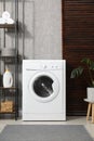 Washing machine, towels and detergents in laundry room Royalty Free Stock Photo