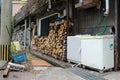 Washing machine and wood logs at Japanese traditional house in Beppu Royalty Free Stock Photo