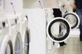 Washing machines in appliance store and defocused buyer Royalty Free Stock Photo