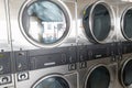 Washing machines with clothes inside at laundromat Royalty Free Stock Photo