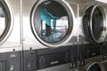 Washing machines with clothes inside at laundromat Royalty Free Stock Photo