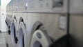 Washing machines, public coin laundry, USA. Self-service laundromat, laundrette.