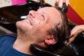 Washing man hair in beauty parlour hairdressing salon Royalty Free Stock Photo