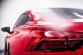 Washing a modern red car at a car wash using a pressure washer Royalty Free Stock Photo