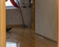 Washing the parquet floor with a mop in the maid 's apartment . The concept of routine household chores Royalty Free Stock Photo
