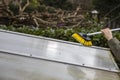 Washing the patio pergola roof cover made of aluminum. removing the dirty algae with brush soap and water close up in