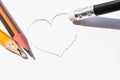 Washing on a pencil erases the painted heart. Simple pencils symbolize ruined love Royalty Free Stock Photo