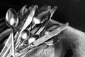 Washing silver spoons, forks and knives in kitchen sink with foam, closeup Royalty Free Stock Photo