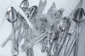 Washing silver spoons, forks and knives under stream of water in kitchen sink, top view Royalty Free Stock Photo