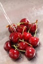 Washing sweet cherries in metal kitchen sink under water jet close-up Royalty Free Stock Photo