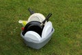 Washing up bowl with dirty pots and plates, on the grass at a ca