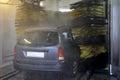 Washing vehicle in automatic car wash Royalty Free Stock Photo