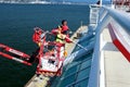 washing windows in large buildings of Canada Place complex two people in overalls paint and wash windows repair with