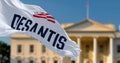 DeSantis flag waving with blurred White House in the background