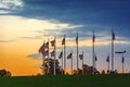 Sunset over waving american flags with tourists and an airplane landing Royalty Free Stock Photo