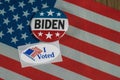 Washington DC--July 5, 2020; Round red white and blue Joe Biden campaign button next to oval shaped I Voted sticker on American