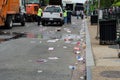 Litter and garbage all over the streets of Washington DC after an event. Crews work to clean up the