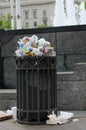 Overflowing trash can on the sidewalk of downtown DC. Concept for garbage, clean up, enviornment,