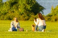 Two caucasian female friends are having picnic on Gravelly Royalty Free Stock Photo