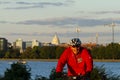 A cyclist wearing Washington Nationals baseball team hoodie with Capitol hill in background