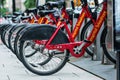 Washington DC, USA - June 9, 2019: Row of Red Bicycles Used in the Capital Bikeshare Program Resting on the side walk - image