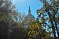 The Rotunda of the U.S. Capitol Building Peaking Above the Trees on a Bright Autumn Morning