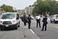 Police officers, police cars and DC municipal trucks serve as a barrier on Third Street next to the Justice of J6 Protest