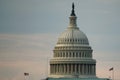 Washington, DC, USA. 08 18 2018. US Capitol dome with two flying flags at dawn or twilight.