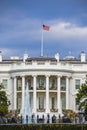 Washington DC, USA. White House view on cloudy day background and american flag. Royalty Free Stock Photo