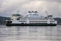 Washington State Ferry MV Suquamish crossing on calm water with clouds Royalty Free Stock Photo