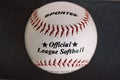 Washington USA 1 May 2022 Official league softball. A white and red vintage leather ball top view on dark background Royalty Free Stock Photo