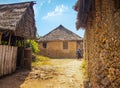 Wasini island, Kenya, AFRICA - February 26, 2020: Woman and typical stone houses in an African village on Wasini island