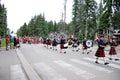 The Prince Albert Highlanders Band and an RCMP and Parks Canada Color Guard march in a parade at Waskesiu to celebrate Canada Day