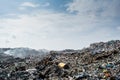 Wastage at the garbage dump full of smoke, litter, plastic bottles,rubbish and trash at tropical island Royalty Free Stock Photo