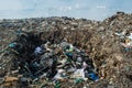 Wastage pit at the garbage dump full of smoke, litter, plastic bottles,rubbish and trash at tropical island Royalty Free Stock Photo