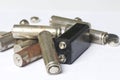 Waste batteries of different types are scattered. On a white background. Royalty Free Stock Photo