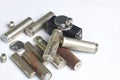 Waste batteries of different types are scattered. On a white background. Royalty Free Stock Photo