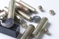 Waste batteries of different types are scattered. On a white background. Royalty Free Stock Photo